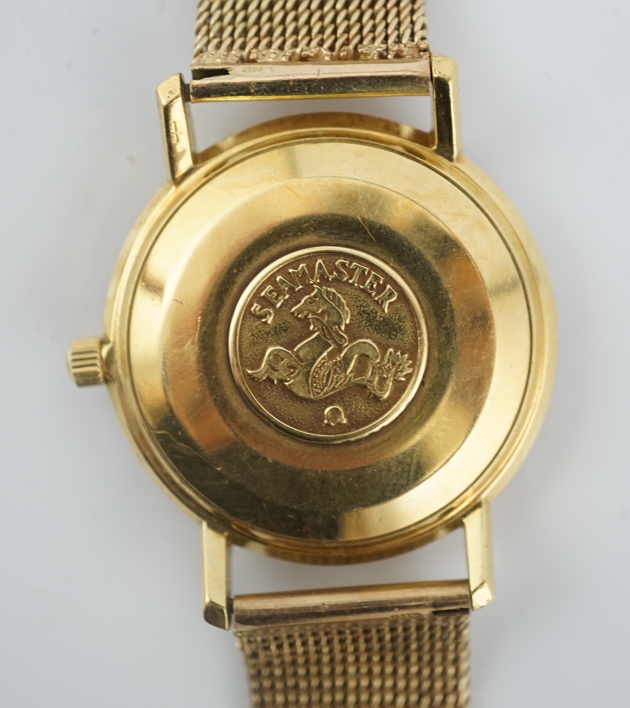 A gentleman's 1960's 18ct gold Omega Seamaster DeVille automatic wrist watch, on an associated 9ct gold bracelet